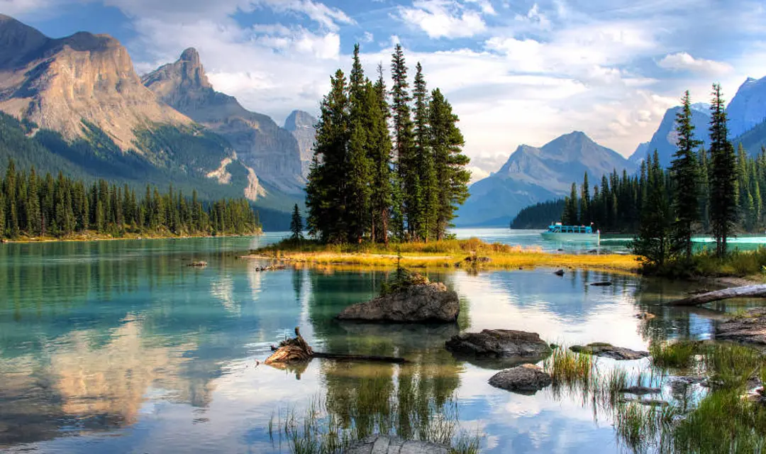 A panoramic view of Jasper with trees reflected in the water