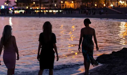 Just You group on beach at night
