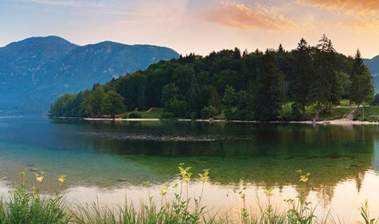 Mountains overlooking lake in SLOVENIA