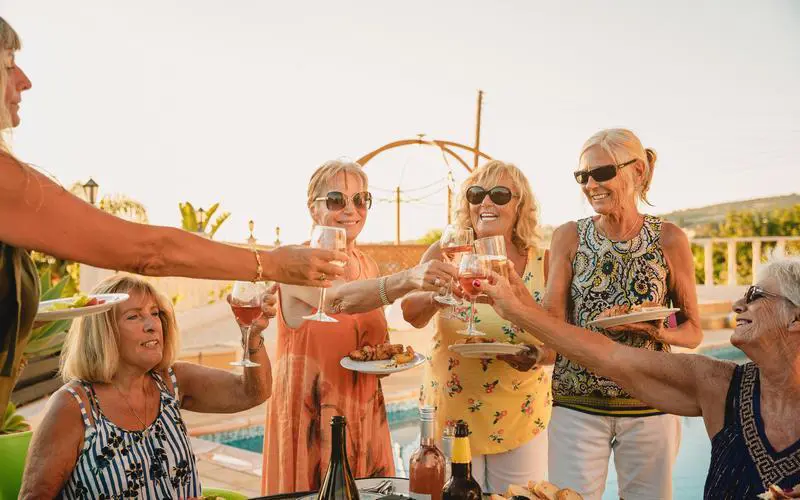 A group of solo travellers getting to know each other over some drinks and nibbles